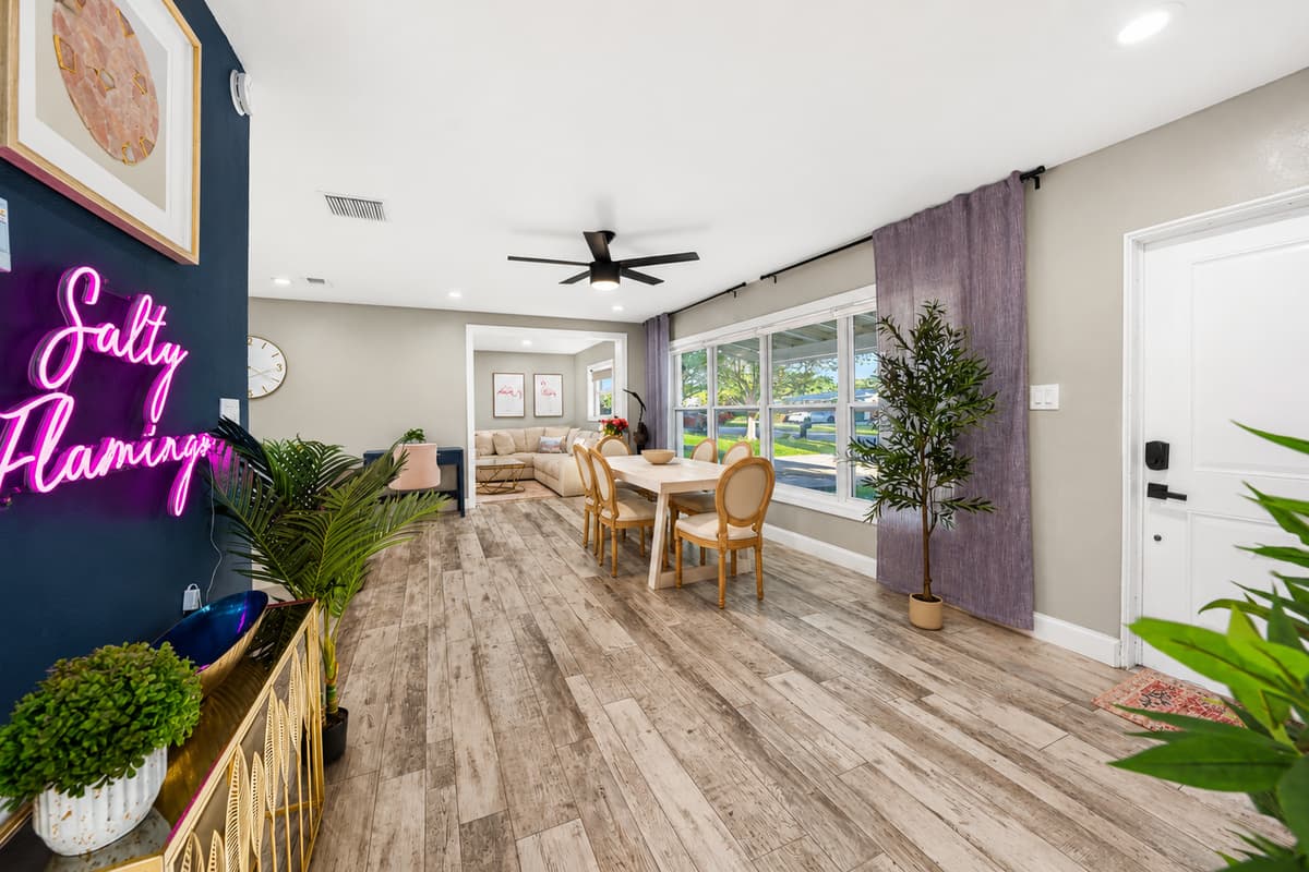 View from the entry area toward the dining room and living spaces, highlighting the home's airy layout and oversized windows.
