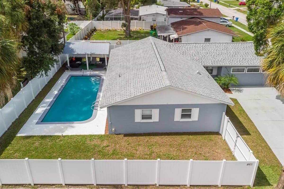 The beautiful back view of this amazing property, showcasing the wonderful swimming pool, fully fenced backyard, and the lovely patio area. Make the most of your stay! Book now!