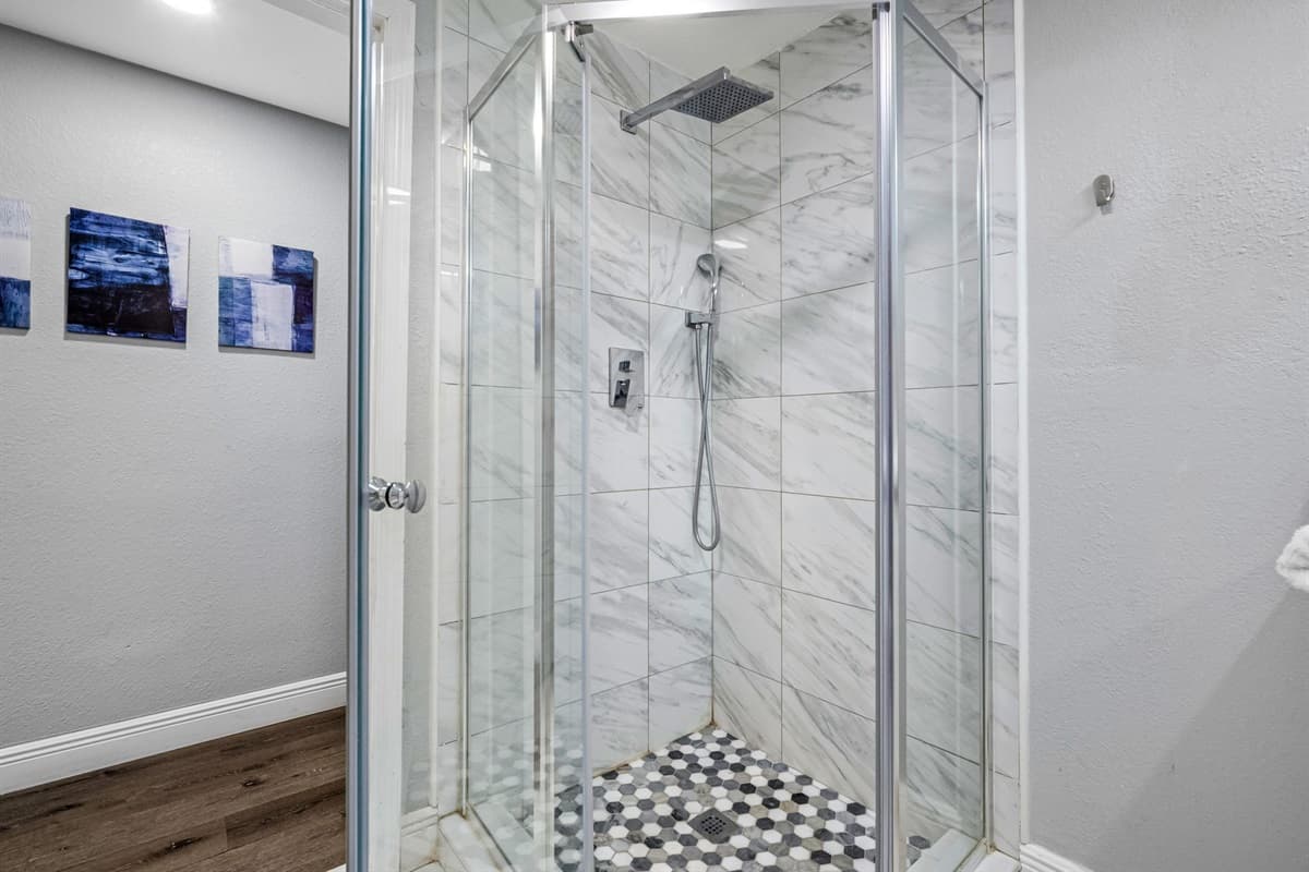 Polished marble tiles and a modern vanity make this bathroom both elegant and practical.