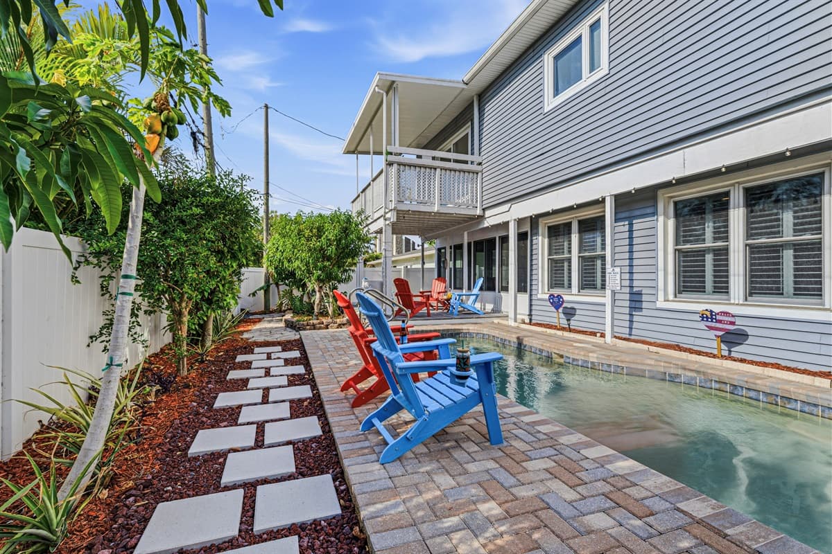 Charming backyard walkway with greenery leading to the pool area—adds a peaceful garden feel 