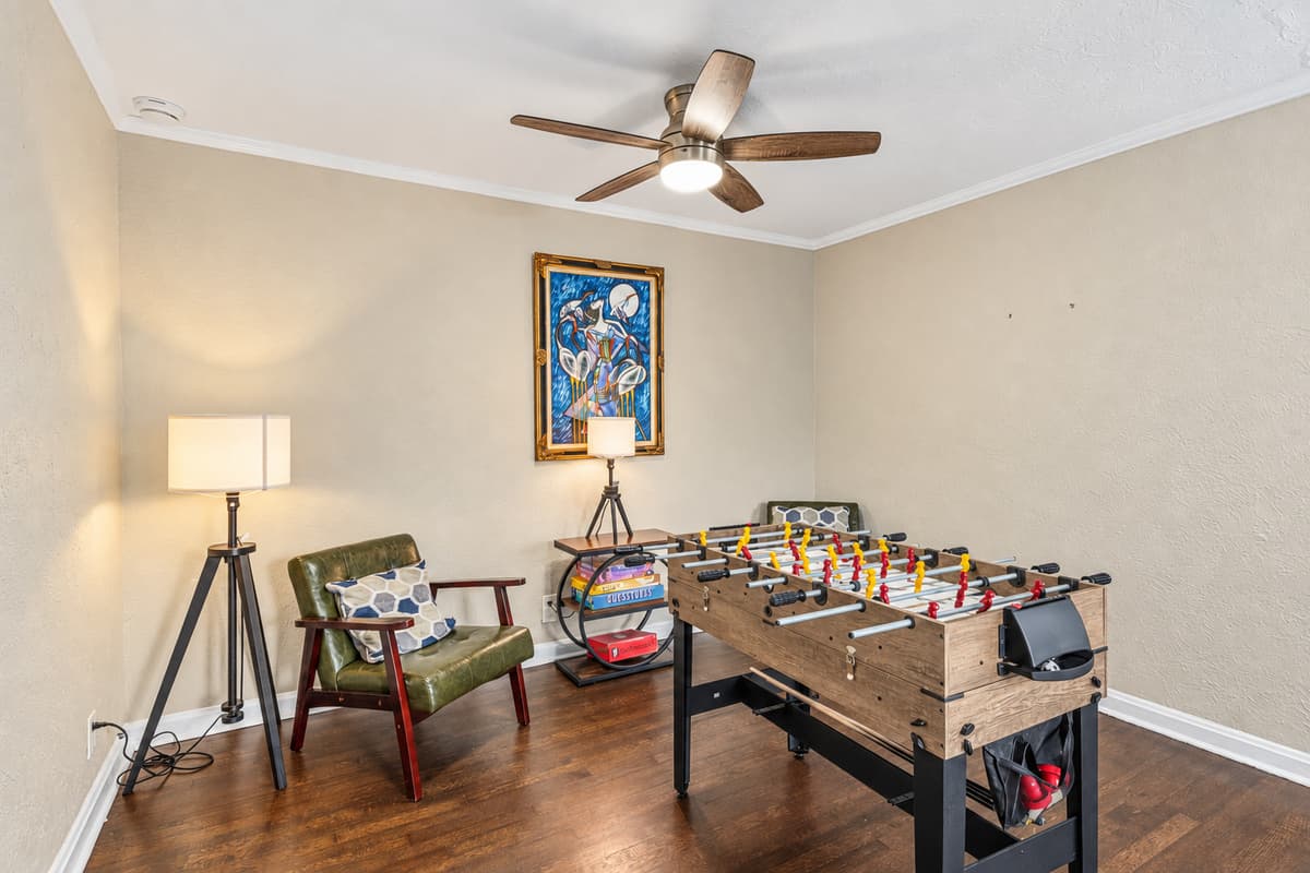 Fun-filled game room featuring a foosball table and cozy seating for friendly competition.