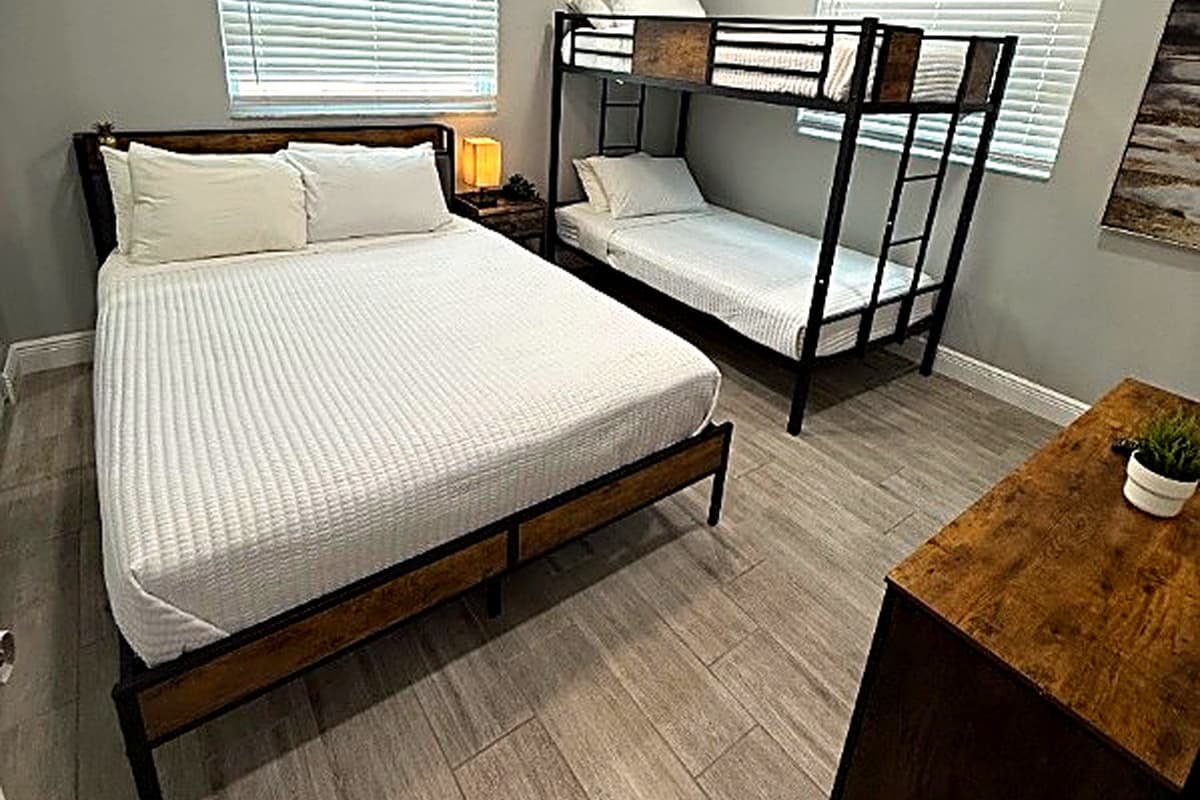Bedroom 3 offers comfortable sleeping arrangements with a queen-size bed and an additional bunk bed—perfect for families or groups.