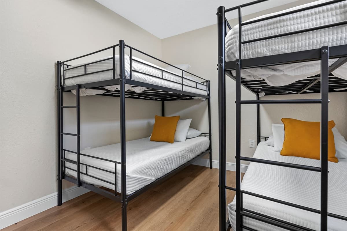 This lively room features two twin-over-twin bunk beds, providing comfortable sleeping arrangements for up to four guests.