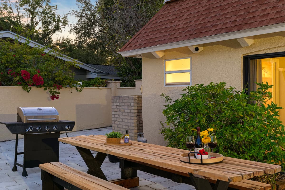 Gather around the rustic picnic table for meals fresh off the grill, just steps away from the shimmering pool.