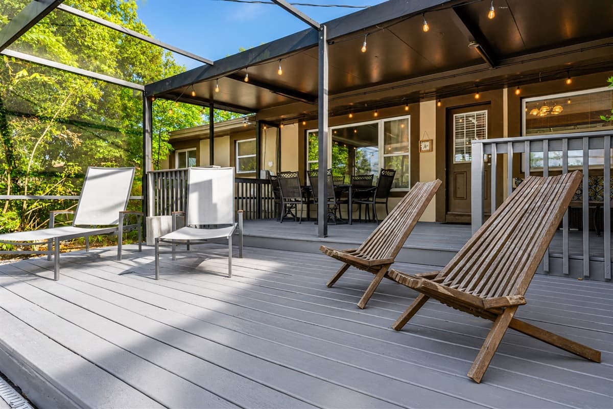 Cozy covered patio and poolside lounge area with ambient lighting and comfortable seating.
