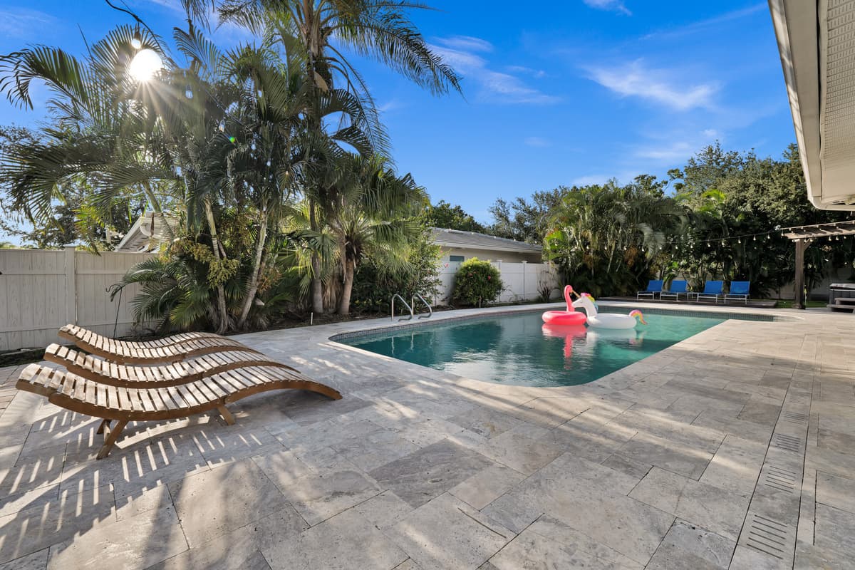 A flamingo float drifts across the pool while loungers sit ready poolside, an easy scene to picture yourself in
