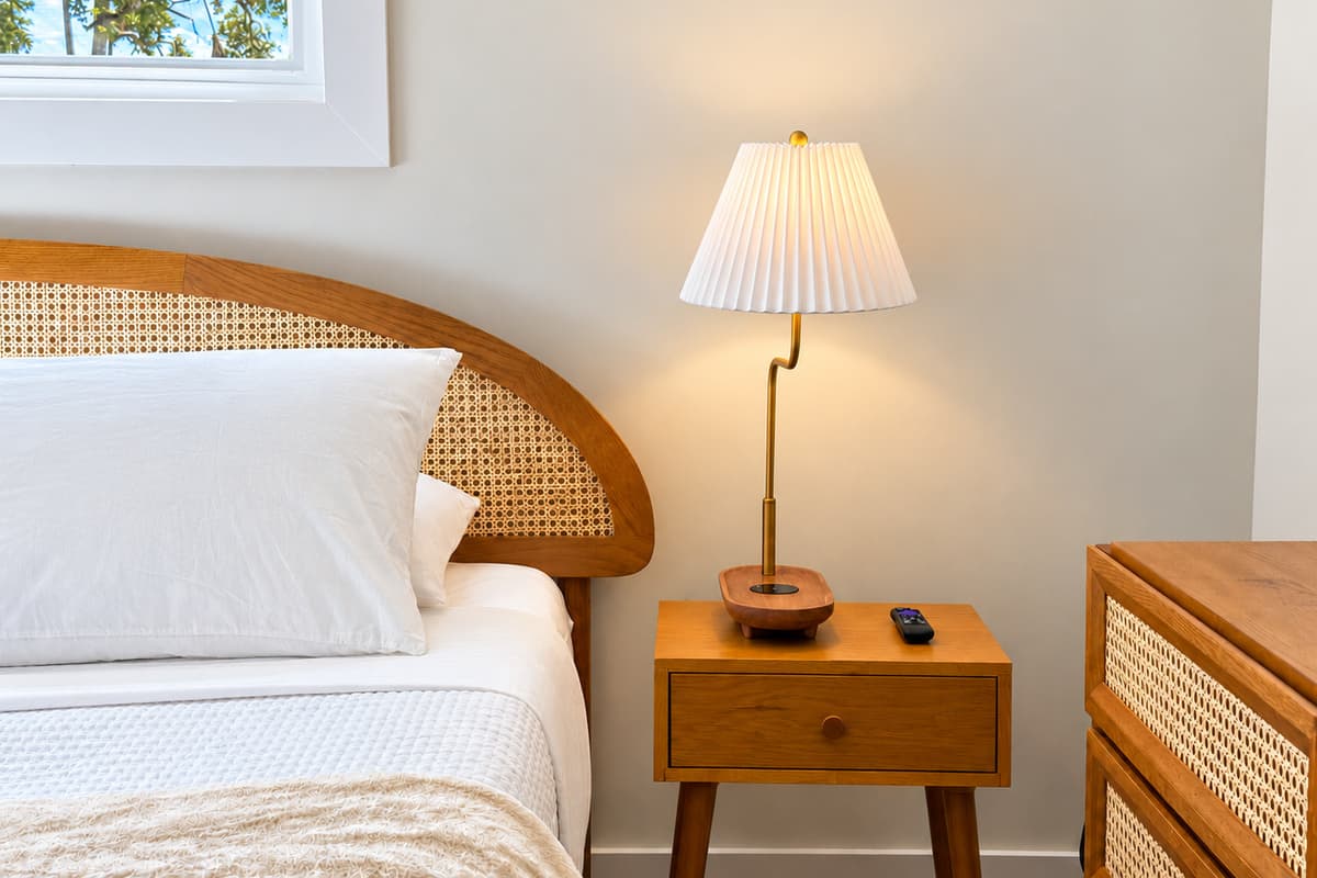 King bedroom bedside lamp and woven headboard detail.