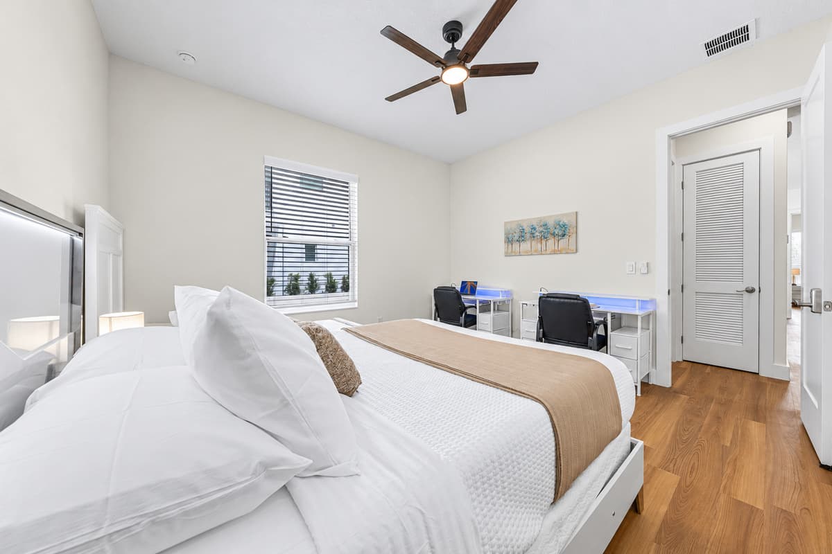Cool off under the ceiling fan after a warm Florida day — blackout blinds ensure a great night's rest.