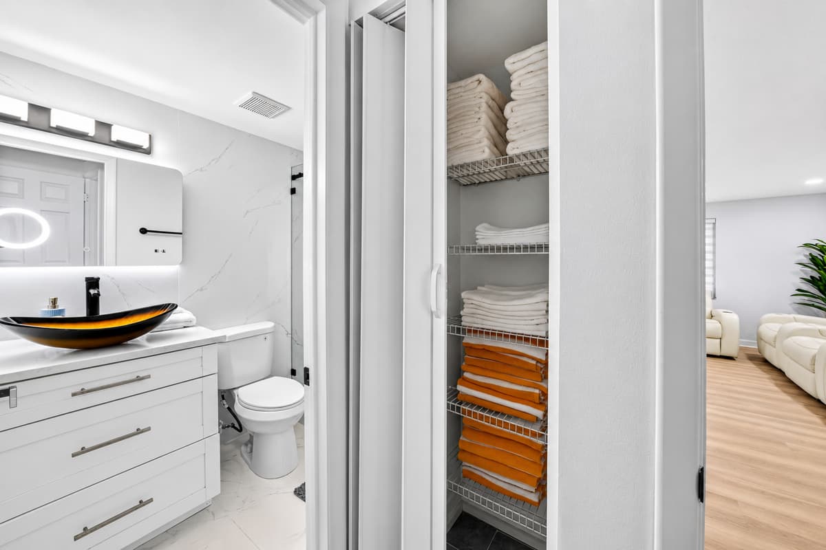 Bedroom 1 - Ensuite
Spacious primary ensuite bathroom featuring a modern vanity, fresh towels, and convenient storage for guest essentials.