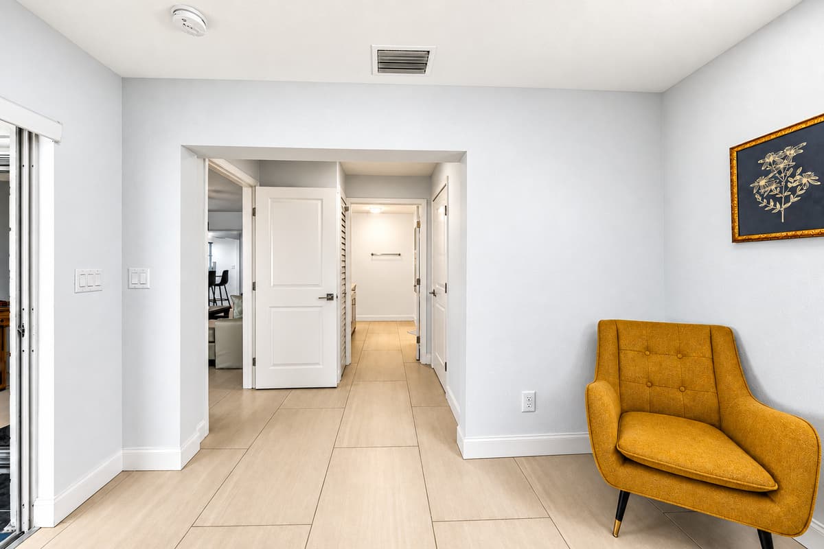 Hallway and seating area leading to the bedroom suite with bright modern finishes.