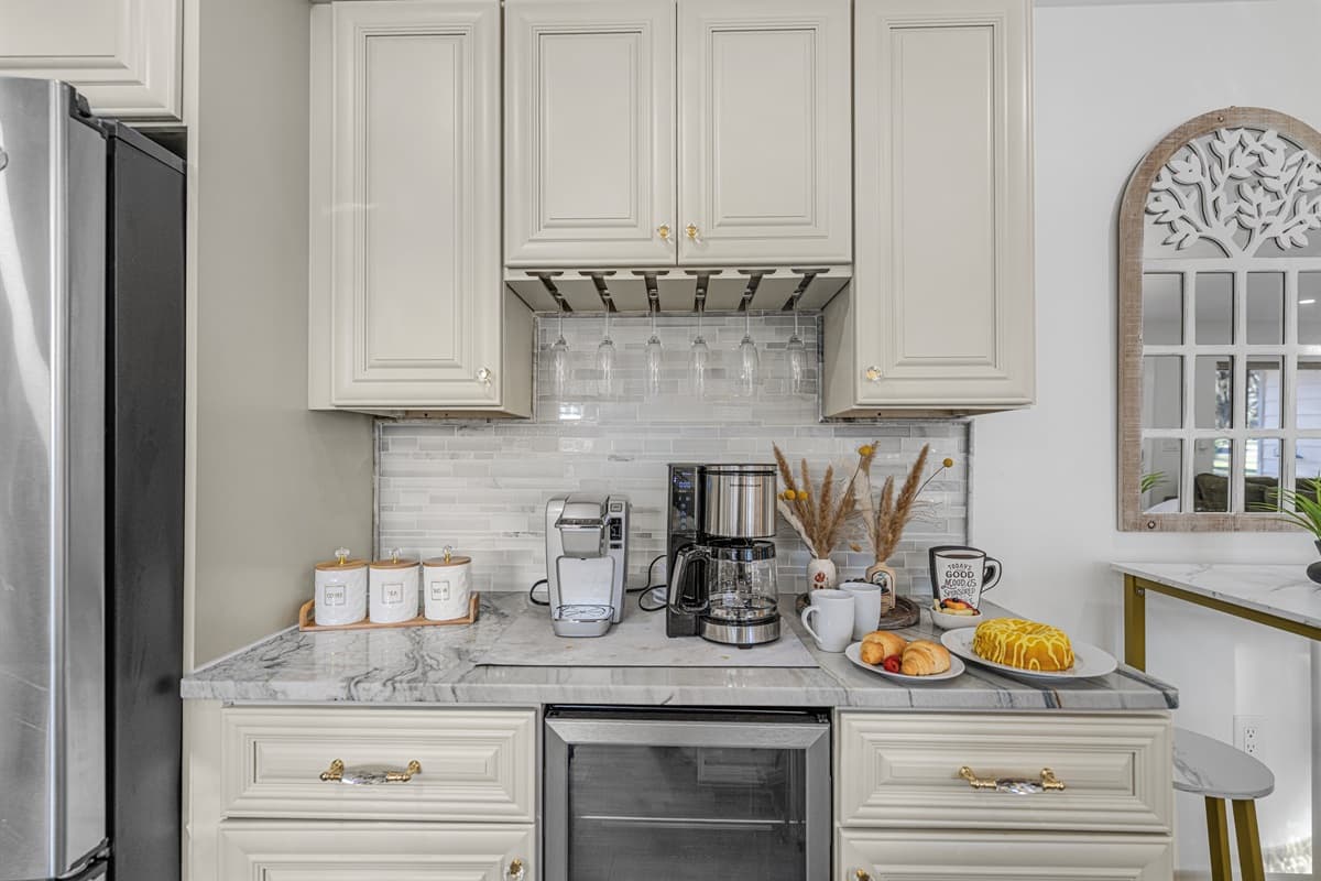 The kitchen features a beautifully styled coffee nook—perfect for slow mornings, fresh pastries, and your favorite brew.