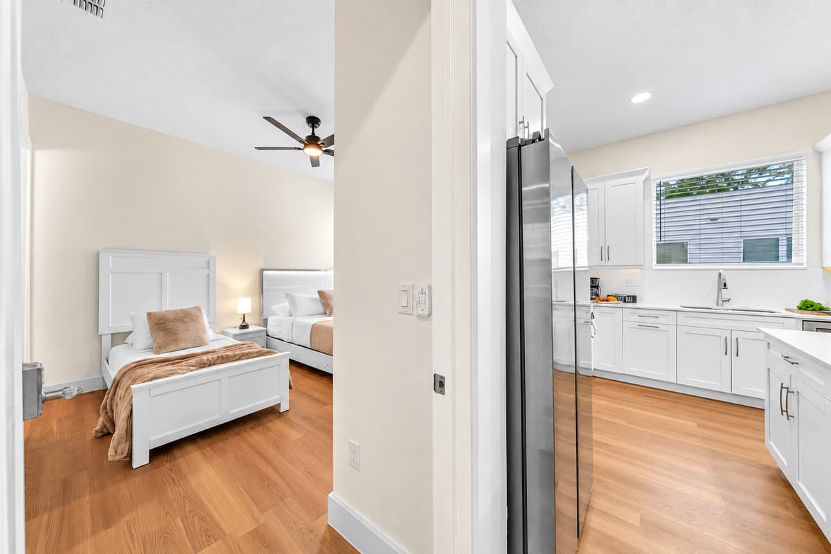 Close to everything, private when it counts. This bedroom sits just off the main living area, so a midnight snack takes seconds. Shut the door and the room turns quiet, with beds ready for a deep night's sleep.