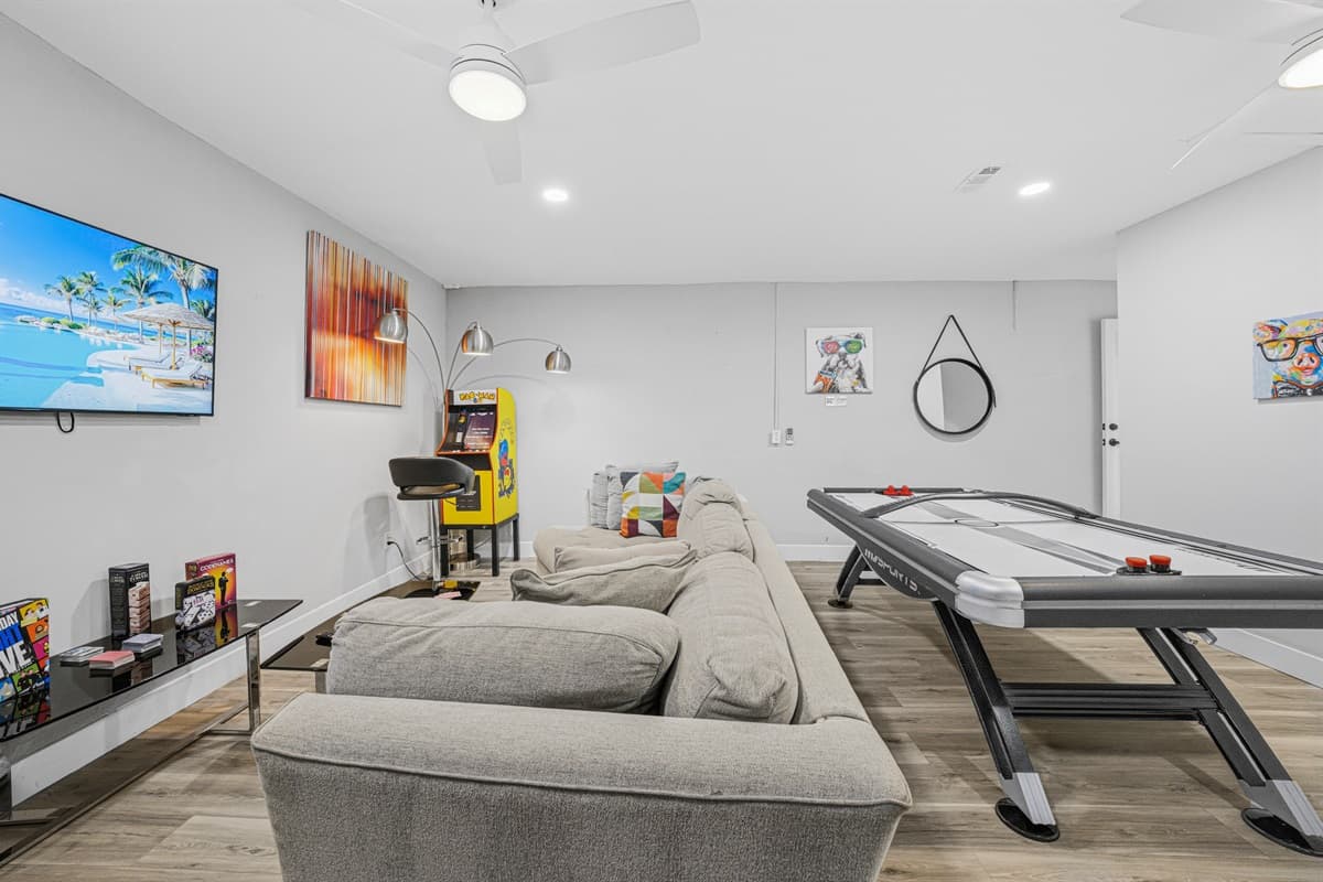 Gather with family and friends in the game room featuring air hockey and a large sectional.