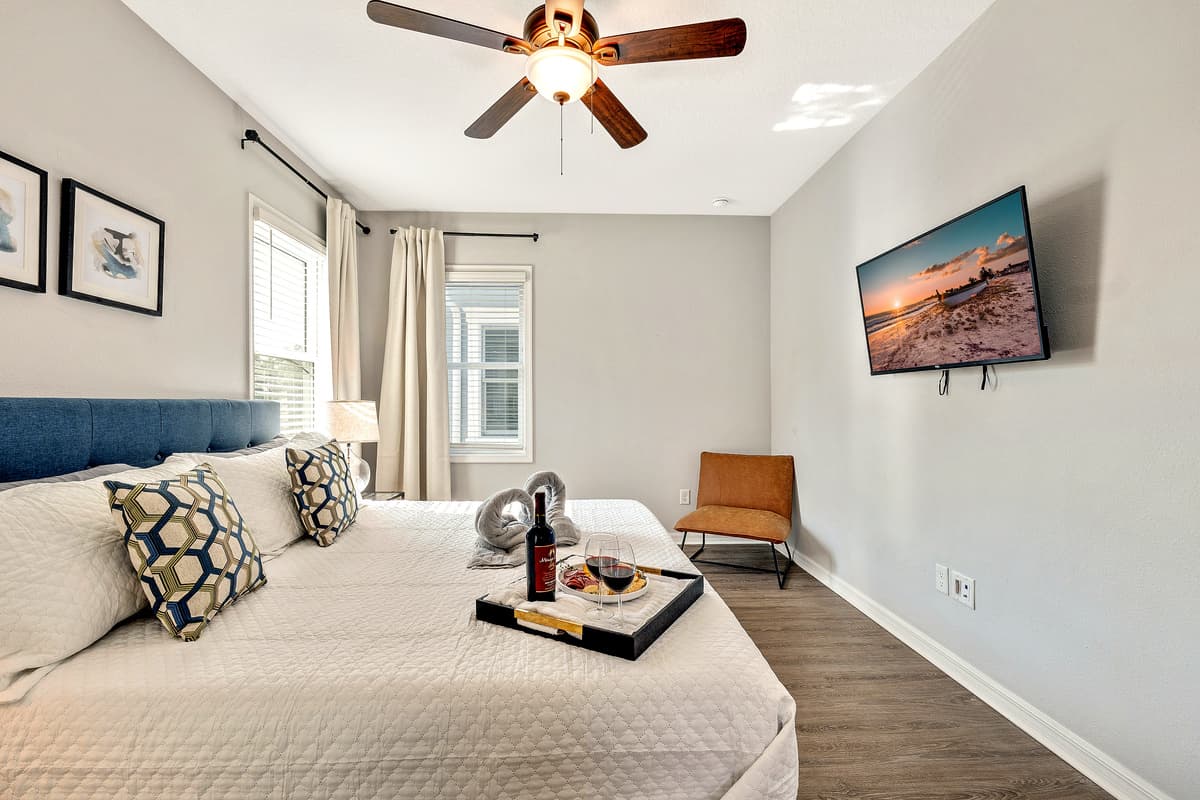 Natural light streams through large windows, casting a warm glow upon the room's tasteful furnishings.