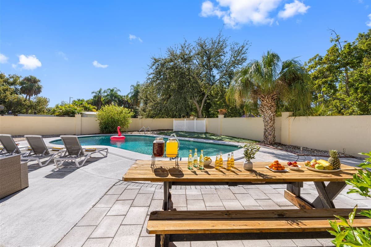 Step into your own private paradise! The shimmering pool, palm trees, and modern patio furniture make this space perfect for relaxation or entertaining.