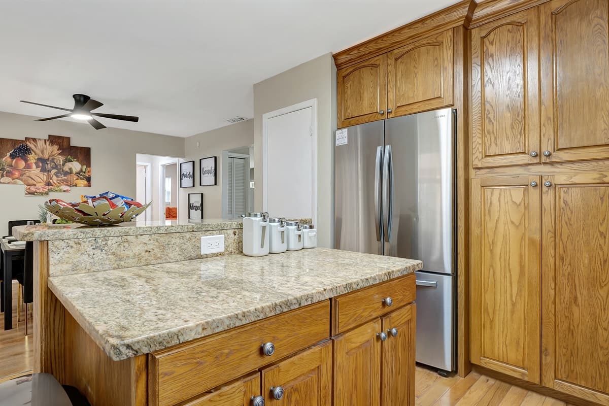 Crafted with solid wooden cabinets, this kitchen exudes a timeless charm while providing ample storage for all your culinary essentials.