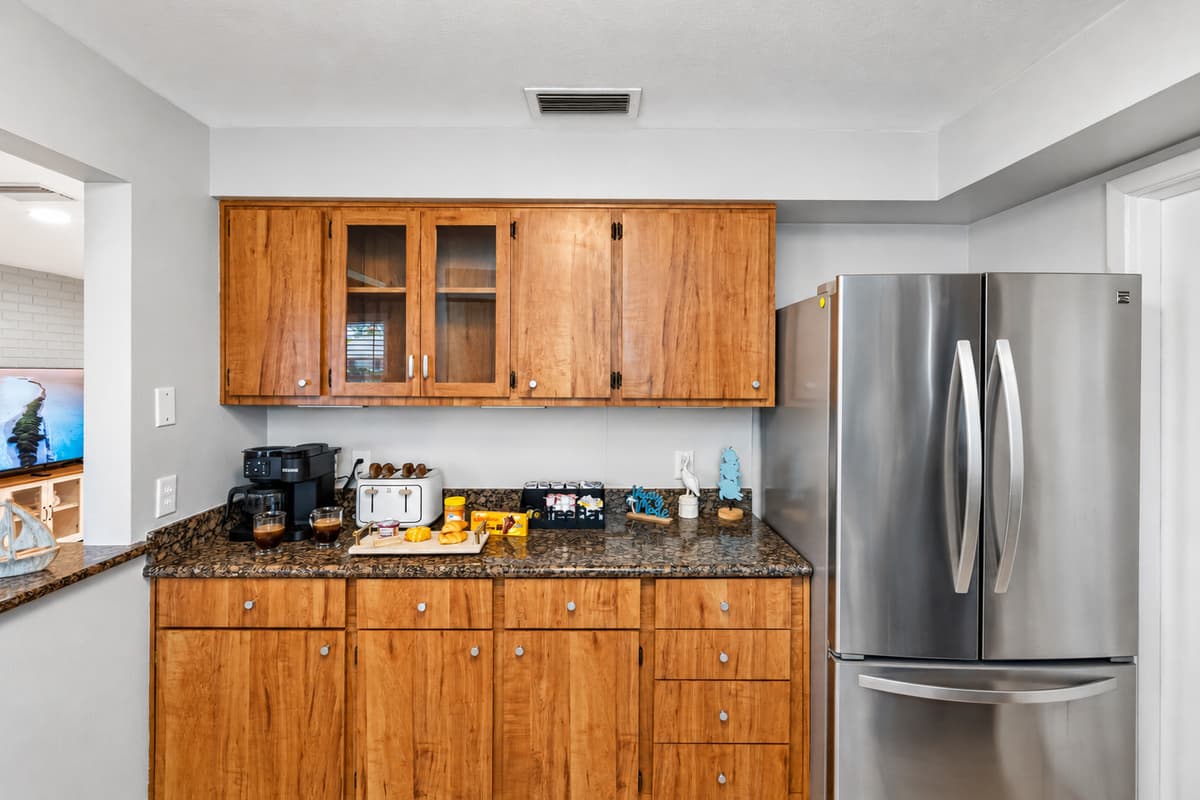 Warm wood cabinetry meets modern convenience in this stylish and functional kitchen.