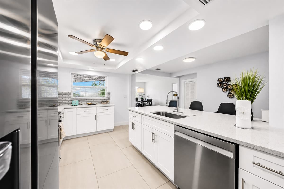 Spacious open-concept kitchen with oversized island, dishwasher, and modern décor.