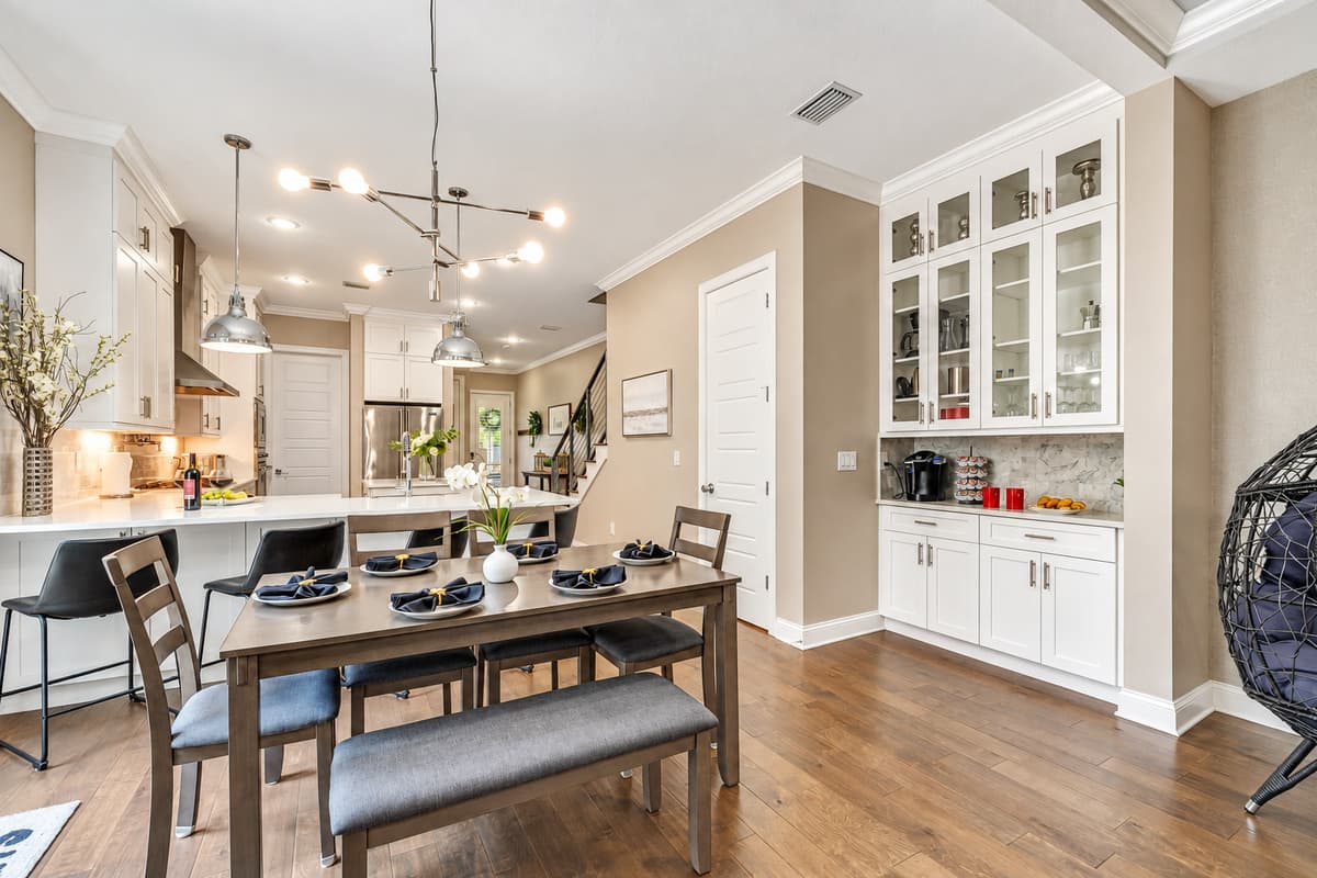On the other side of the dining area, the fully equipped kitchen stands ready to support your culinary endeavors.