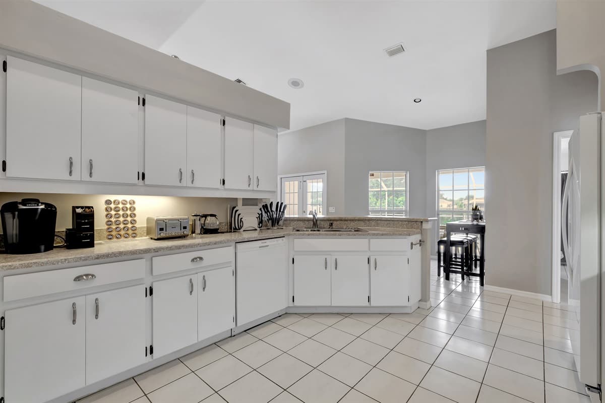 The classic white kitchen cupboards and the attention to detail in every element reflect a harmonious blend of style and functionality.