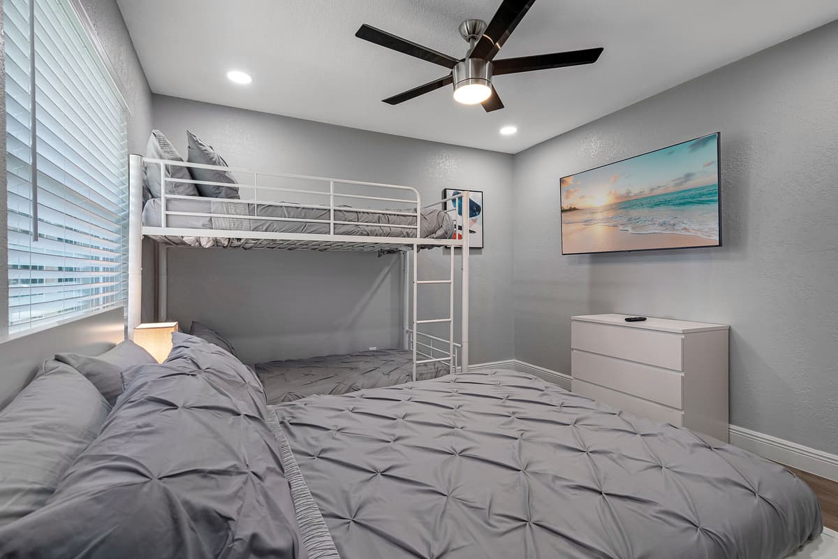 This elegant bedroom is perfect for a small family or group of friends! It has a queen sized bed, single bunkbed, drawers for storage and a smart TV! Book this property now!