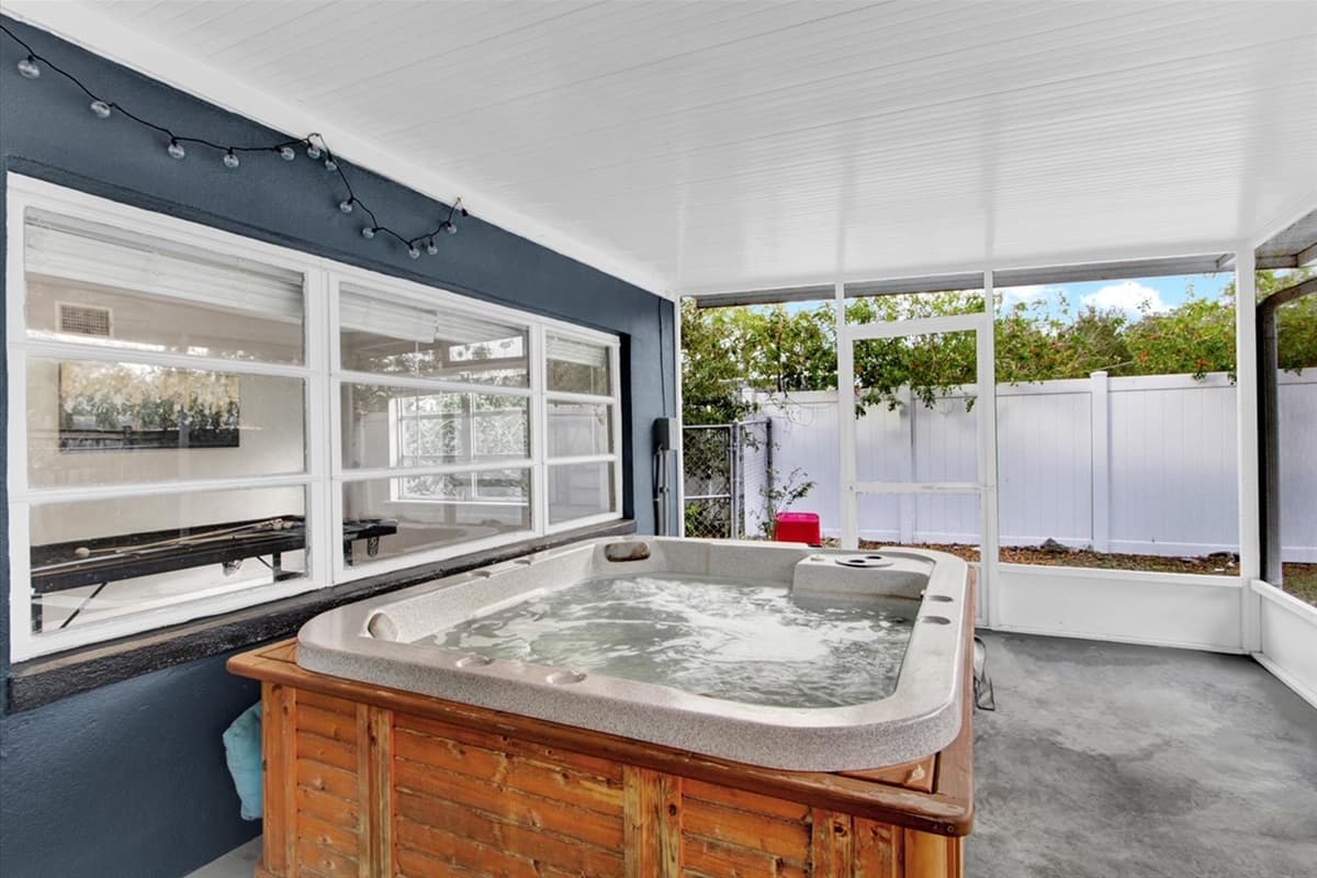 The centerpiece of this al fresco paradise? A bubbling hot tub that promises a symphony of relaxation.