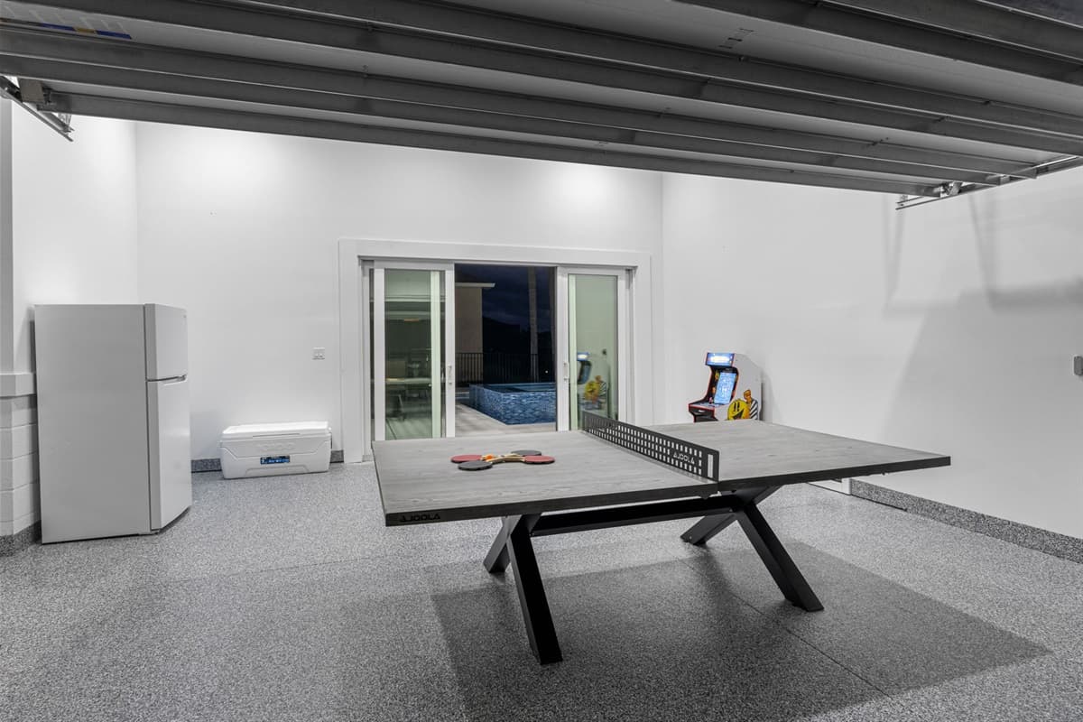 At the heart of this entertainment zone is a high-quality table tennis setup, featuring a regulation-sized table equipped with a professional-grade net.