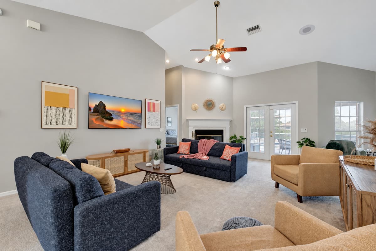 Two luxurious dark blue sofas take center stage, offering ample seating for relaxation and socializing.