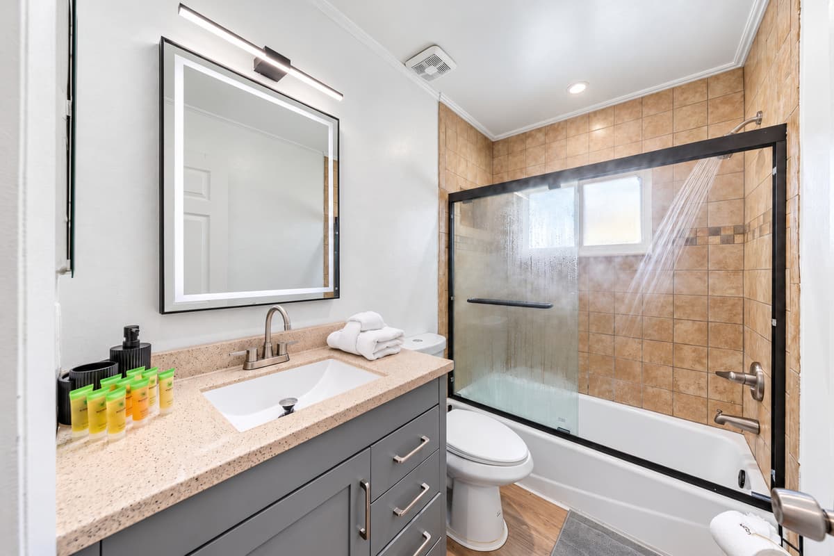 Contemporary lighting, sleek faucet hardware, and a spacious vanity bring hotel vibes to your stay.