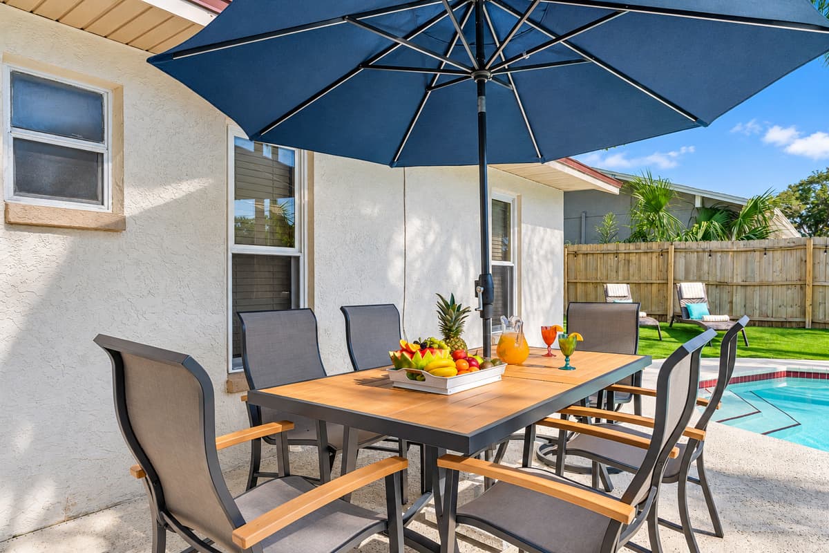 Imagine stepping into your private oasis, where the outdoor dining space beckons with the promise of relaxation and enjoyment.
