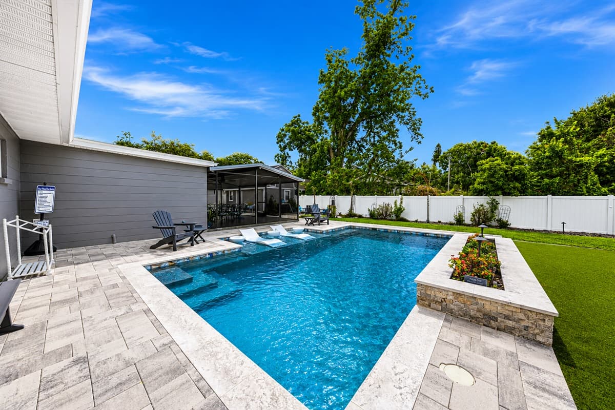 Modern poolside retreat with wide patio deck, comfortable lounge seating, and relaxing outdoor ambiance.