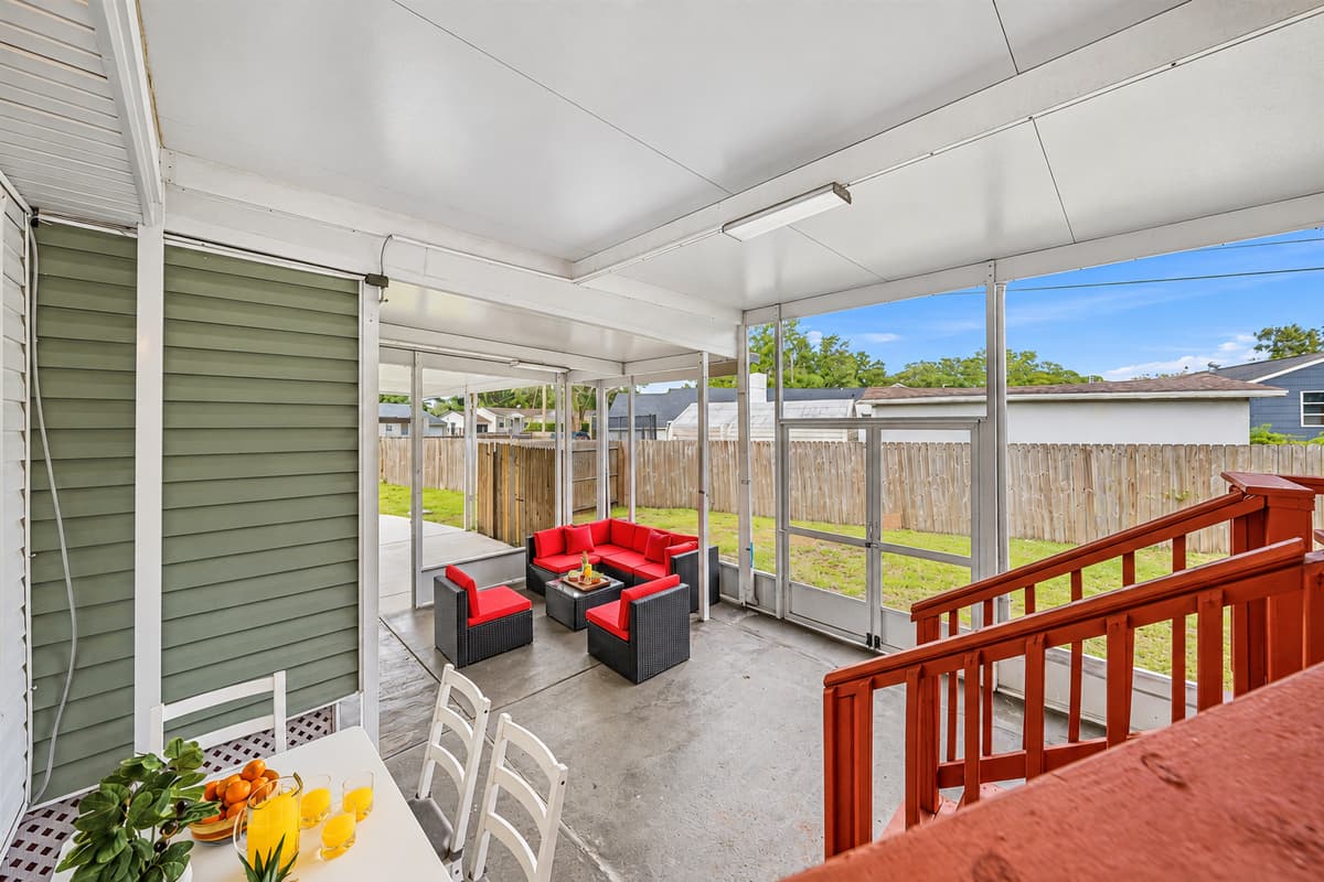 Elevated view of the spacious screened patio with comfortable seating and backyard views.