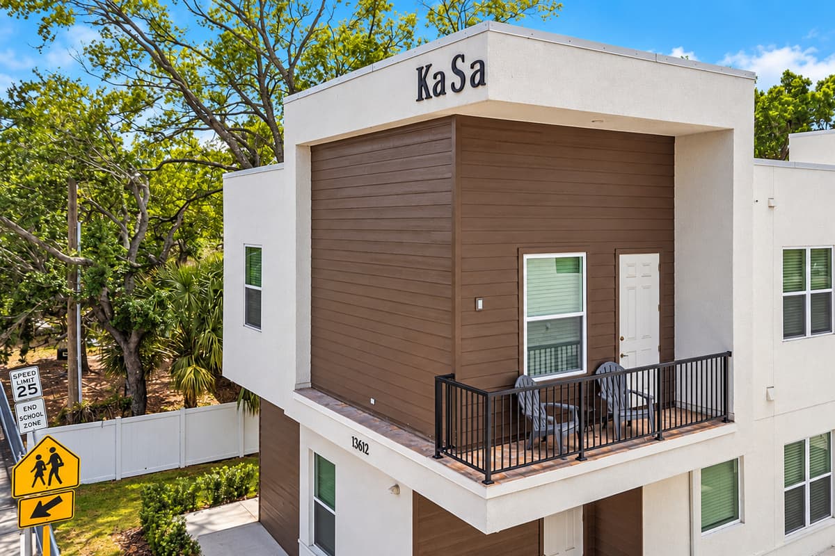 That balcony up there? It's yours. Look up: the covered balcony with two chairs belongs to your 2nd-floor unit. Private entrance, smart-lock self check-in, and free parking for up to 3 cars right below.
