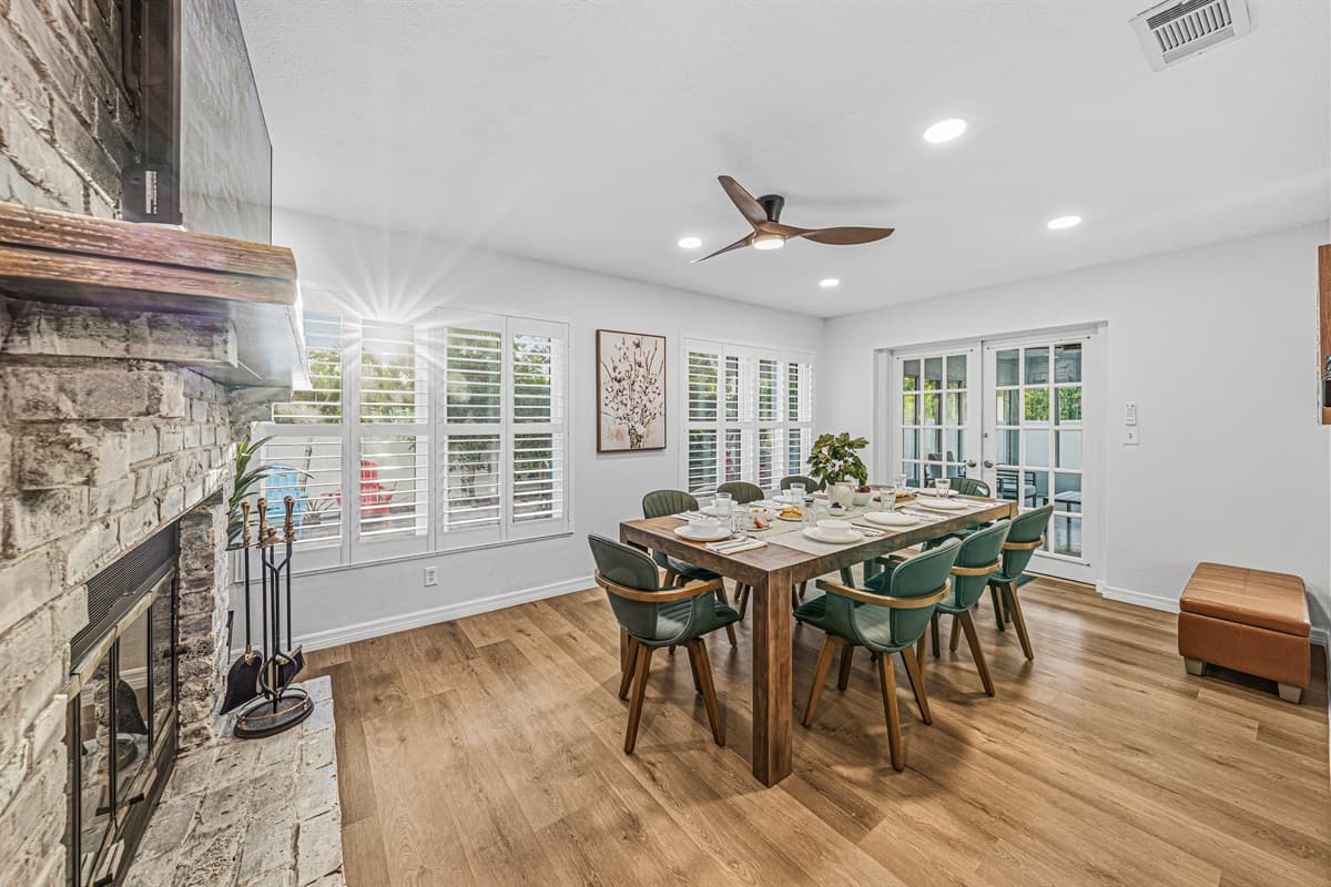 Dining area beside a beautiful stone fireplace—perfect for cozy meals and gatherings 
