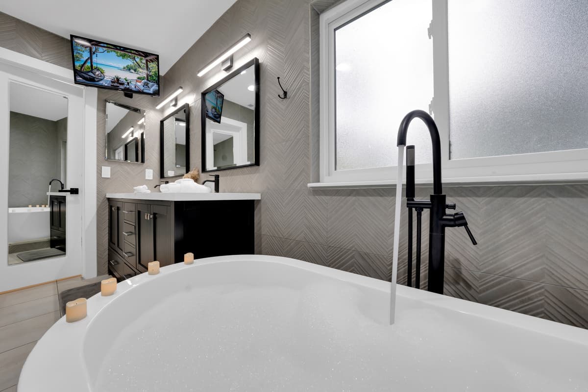 A soaking tub, a mounted TV: the bath doesn't have to be a break from the show, just a change of seat.