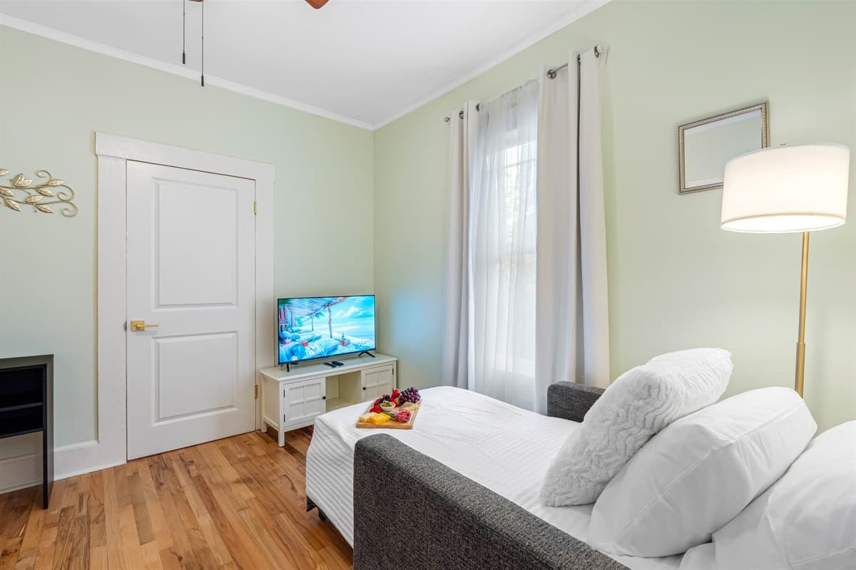The cozy setup creates an inviting atmosphere with comfortable seating, ideal for reading, working on a laptop, or simply enjoying a cup of coffee.