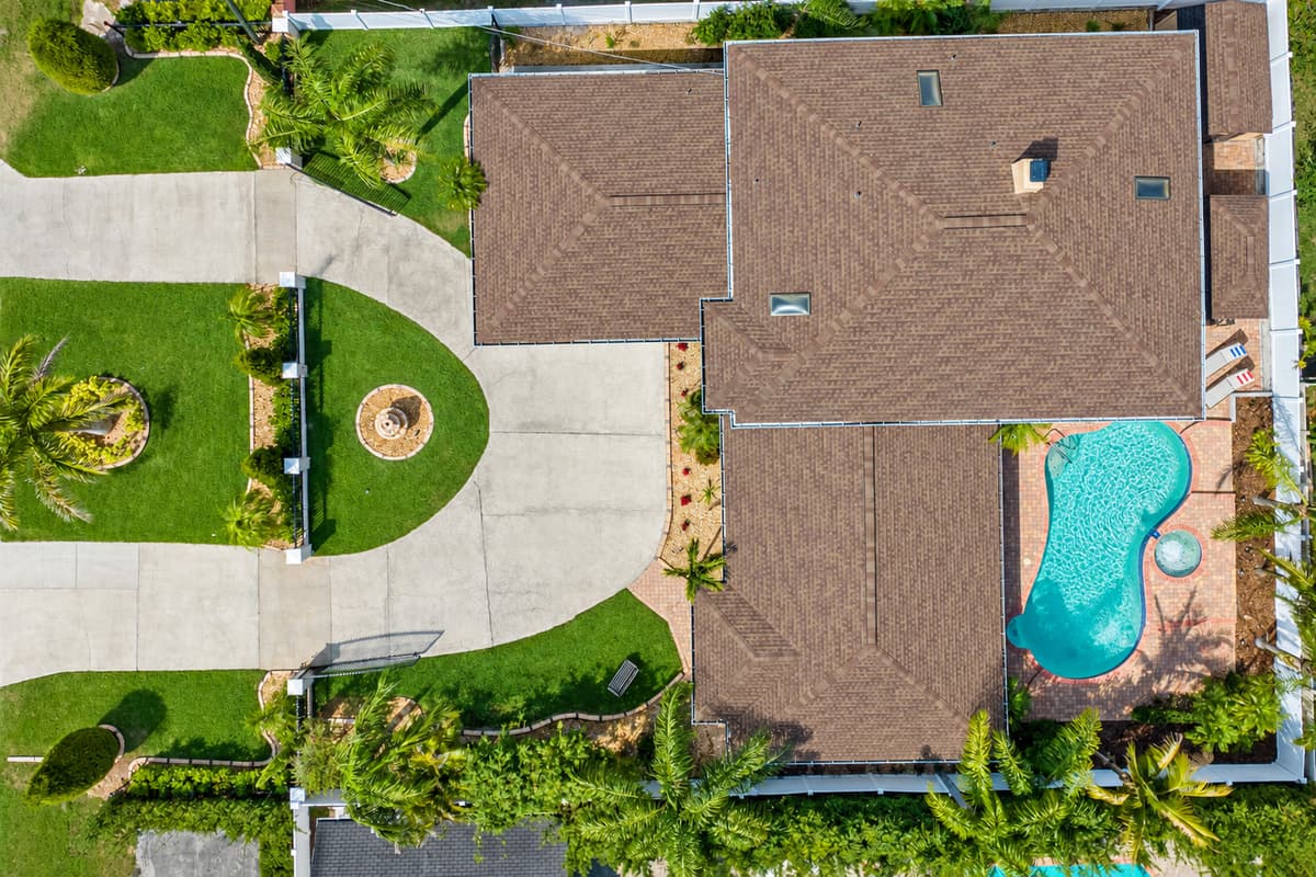 Aerial view of the house boasting its beautiful in-ground pool.