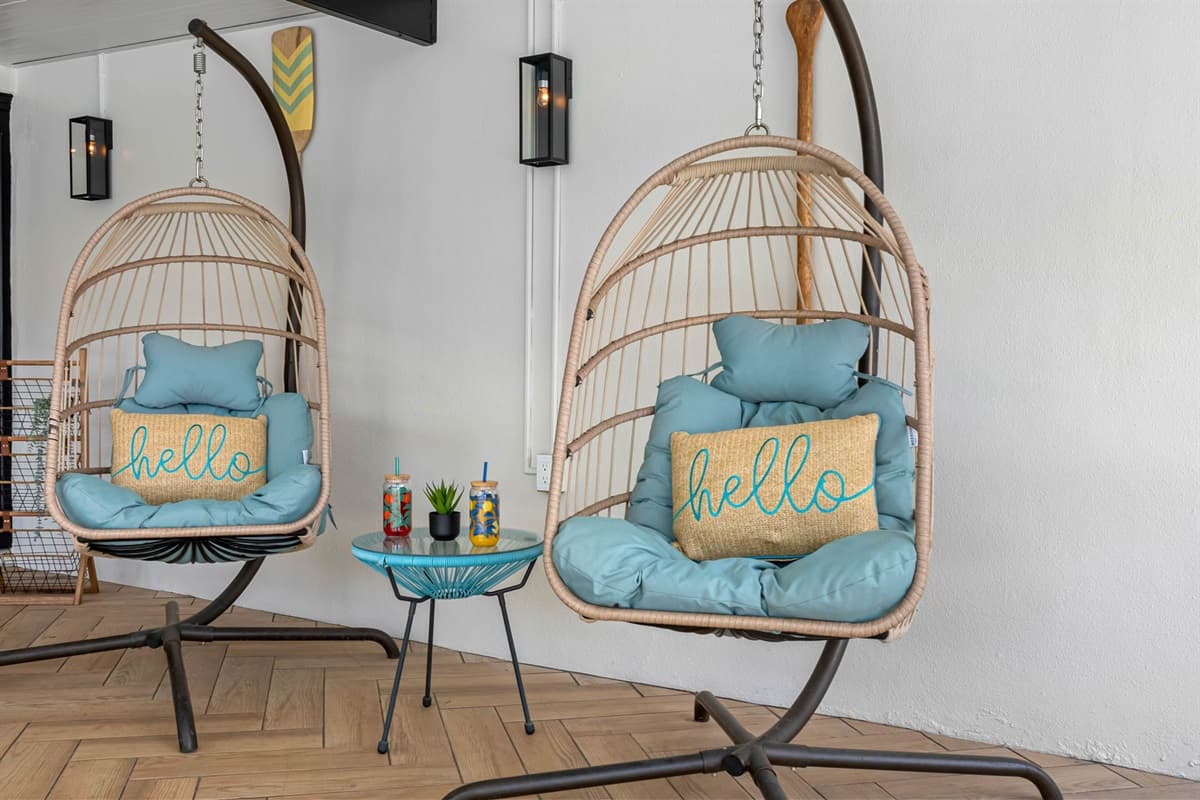 From the cool aqua patio chairs to the swinging egg seats and pool just steps away, every corner of this outdoor area is designed for fun, laughter, and laid-back lounging.