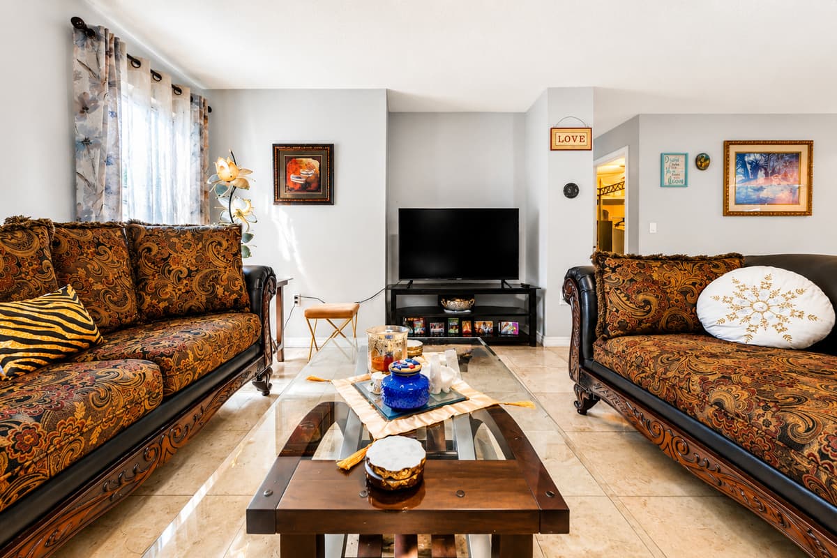 Enjoy movie nights and quality time in this spacious living room with ample seating.