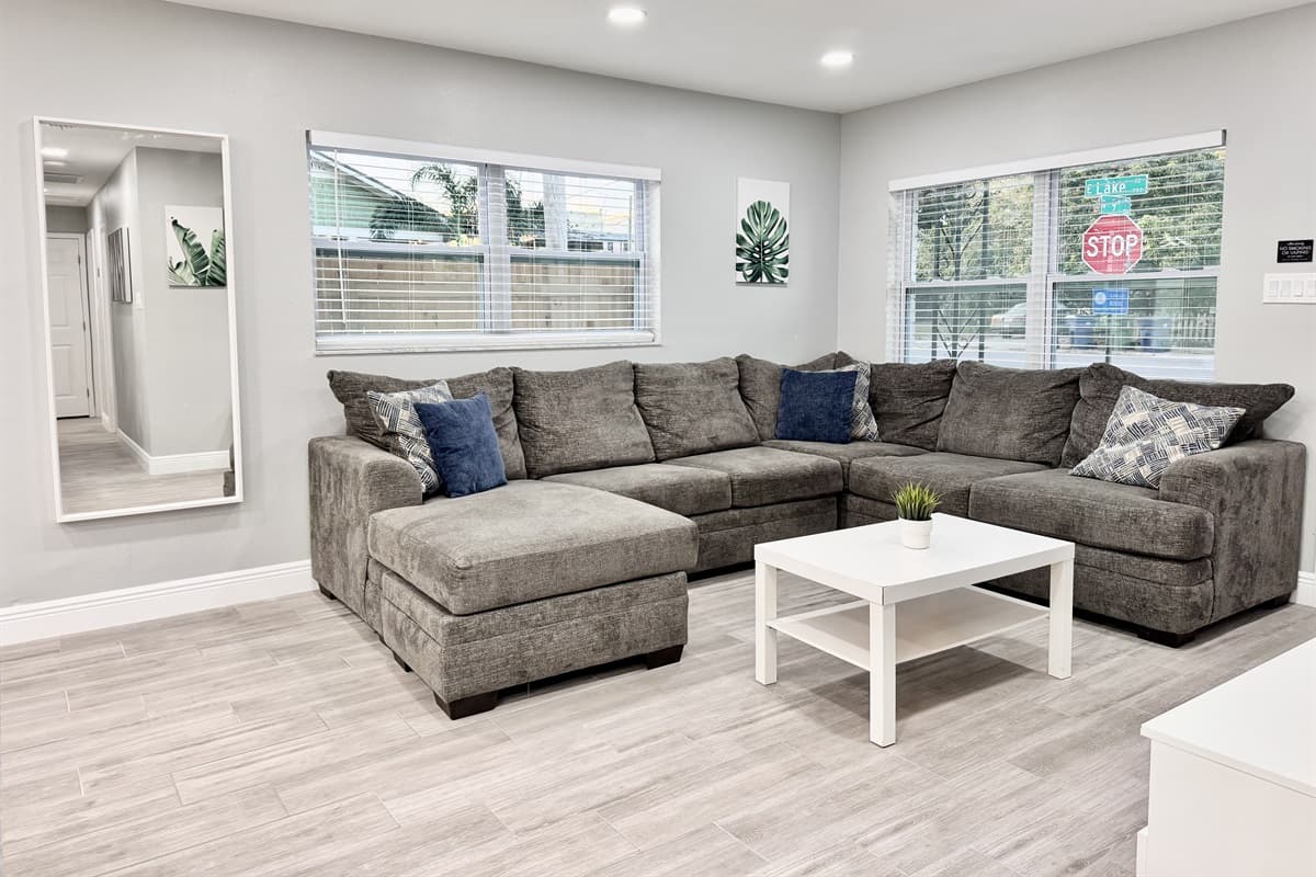 Upholstered in soft, durable fabric and accented with cozy throw pillows, the sofa invites you to kick back and relax.