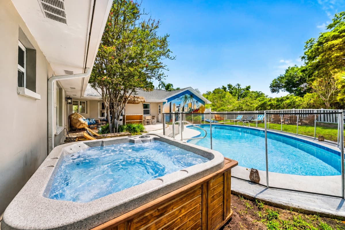 Hot tub beside the pool, not across the yard. Swim, soak, repeat without drying off.