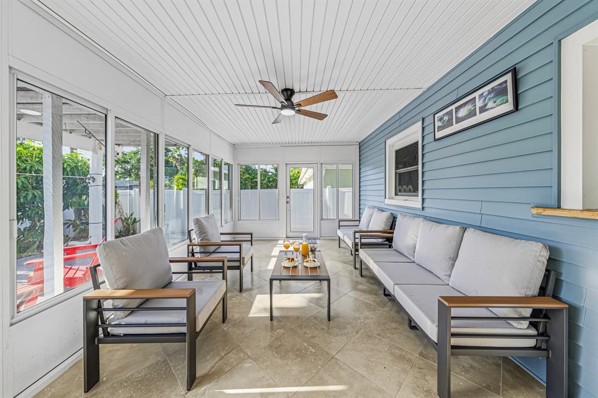 Bright enclosed patio with modern seating and open views—ideal for indoor-outdoor living 
