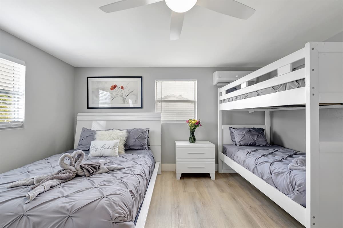 This chic bedroom features a queen-sized bed, bunk bed, ample drawers, and a smart TV, making it an ideal choice for either a group of friends or a family with children.