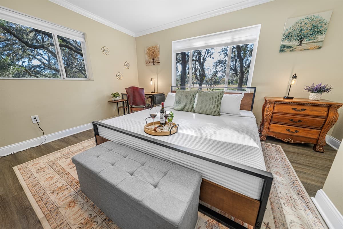 This welcoming bedroom offers a king-size bed, tasteful furnishings, and a calm ambiance ideal for a restful stay.