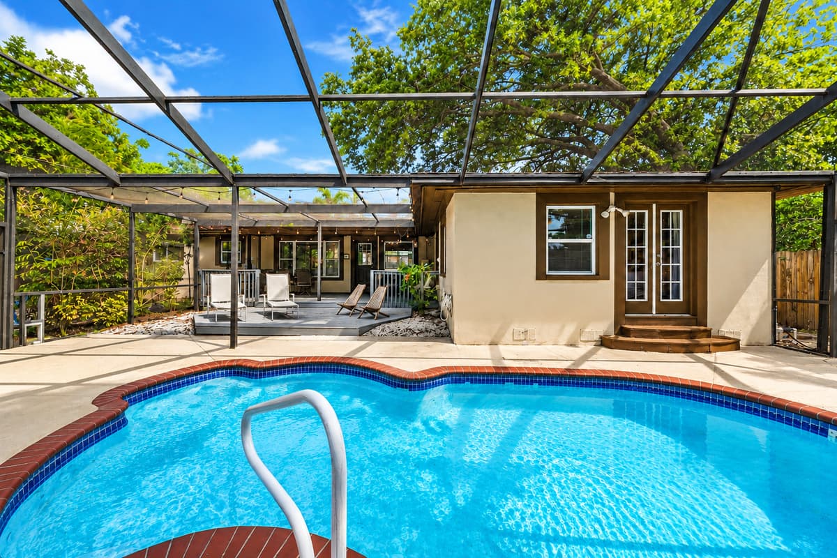 Beautiful backyard pool with relaxing views of the covered patio and outdoor entertainment area.