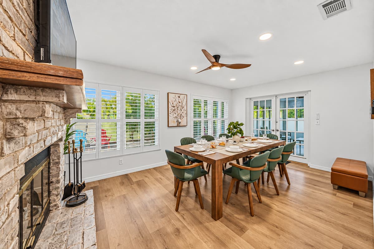 Dining area beside a beautiful stone fireplace—perfect for cozy meals and gatherings 