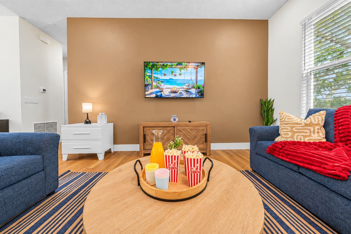 Cozy seating area with TV and warm décor, ideal for movie nights.