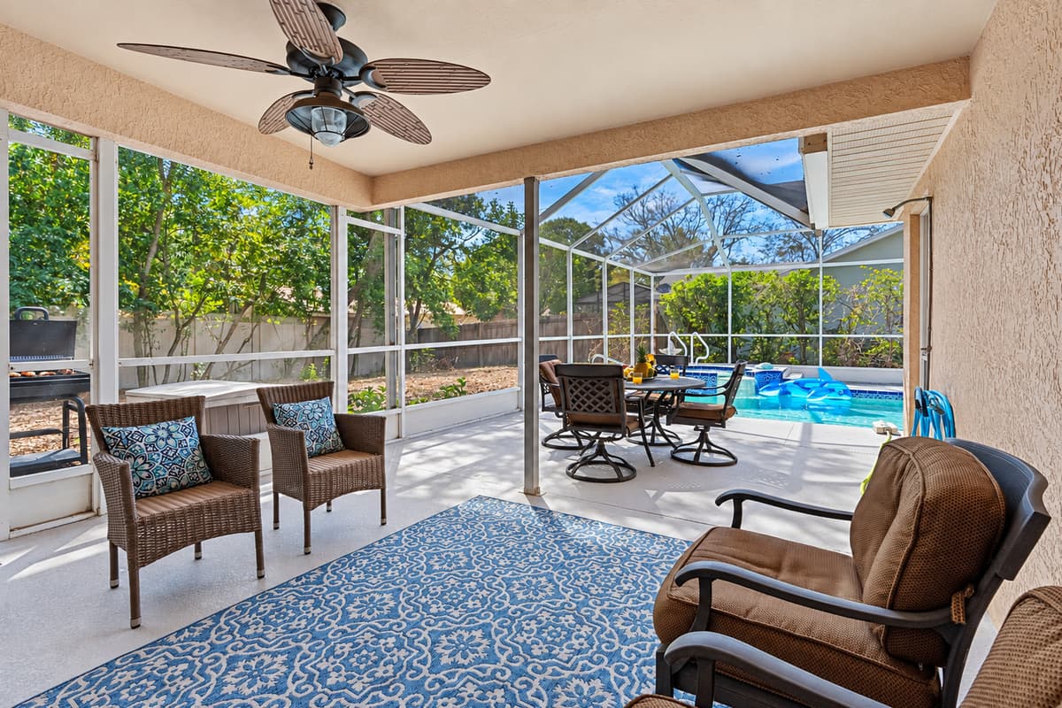 While the surrounding patio area is beautifully appointed with comfortable seating, a dining table, and plenty of space to stretch out and relax.
