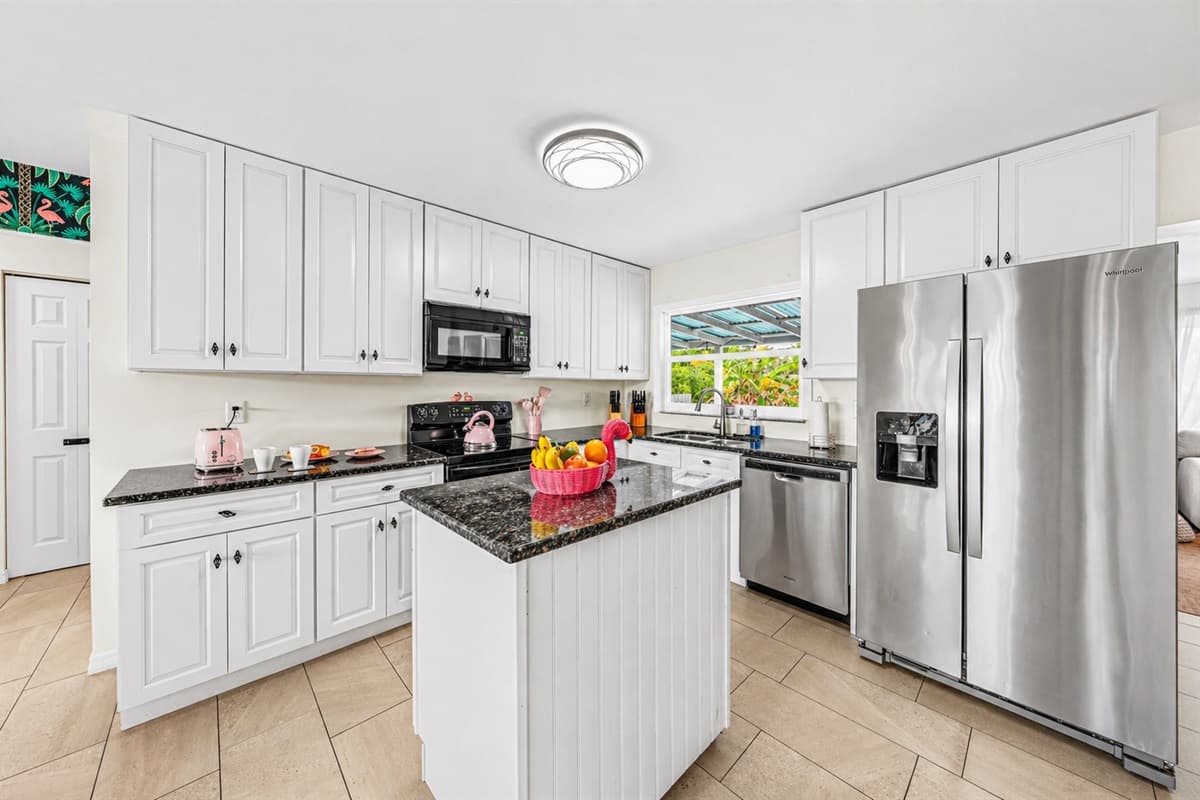 Fully equipped kitchen featuring stainless steel appliances and ample counter space.