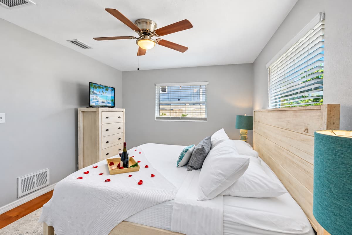 This dreamy bedroom sets the tone for a perfect couple’s escape—complete with soft lighting, plush pillows, and thoughtful romantic touches like rose petals and wine to welcome you.